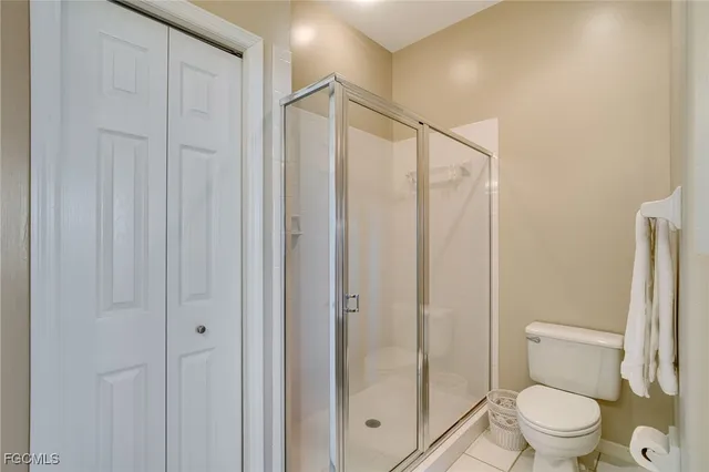 a bathroom with a shower a toilet and a sink