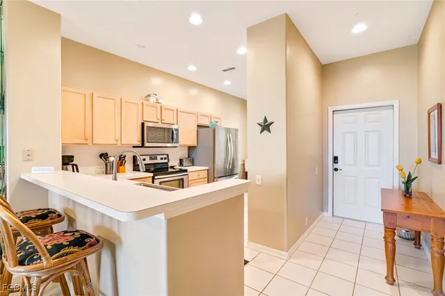 a kitchen with a sink appliances and cabinets