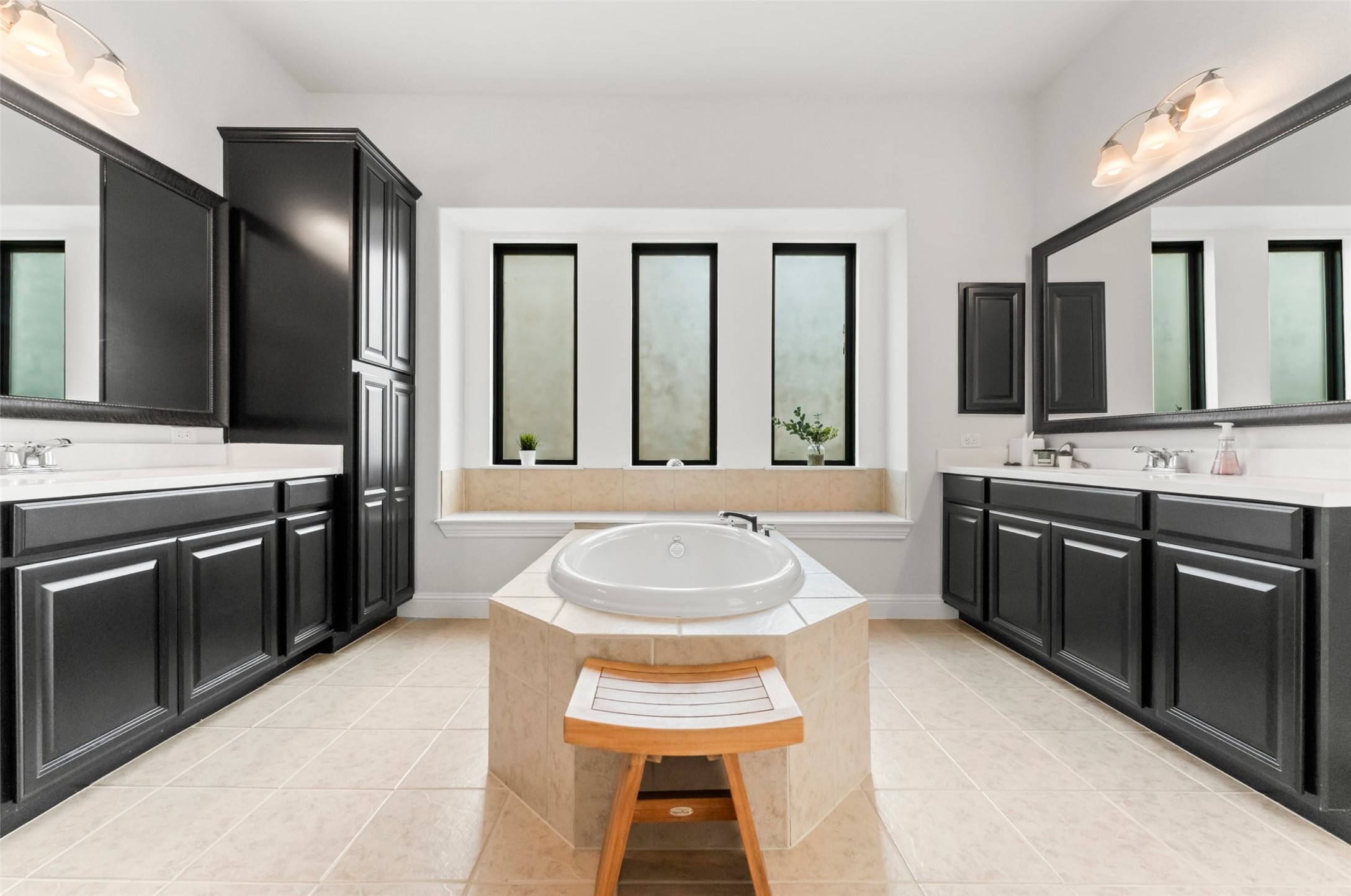1053 Bat Hawk Court Conroe, TX 77385 - Photo 28 of 50 a spacious bathroom with a sink double vanity and a large mirror