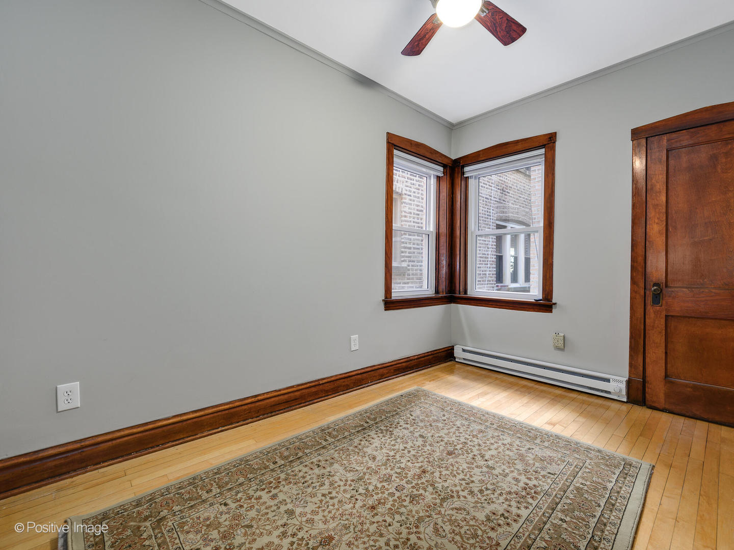 3016 South Throop Street Chicago, IL 60608 - Photo 12 of 32 an empty room with windows and fan