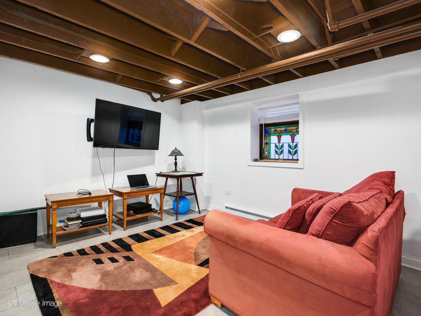 3016 South Throop Street Chicago, IL 60608 - Photo 21 of 32 a living room with furniture and a flat screen tv