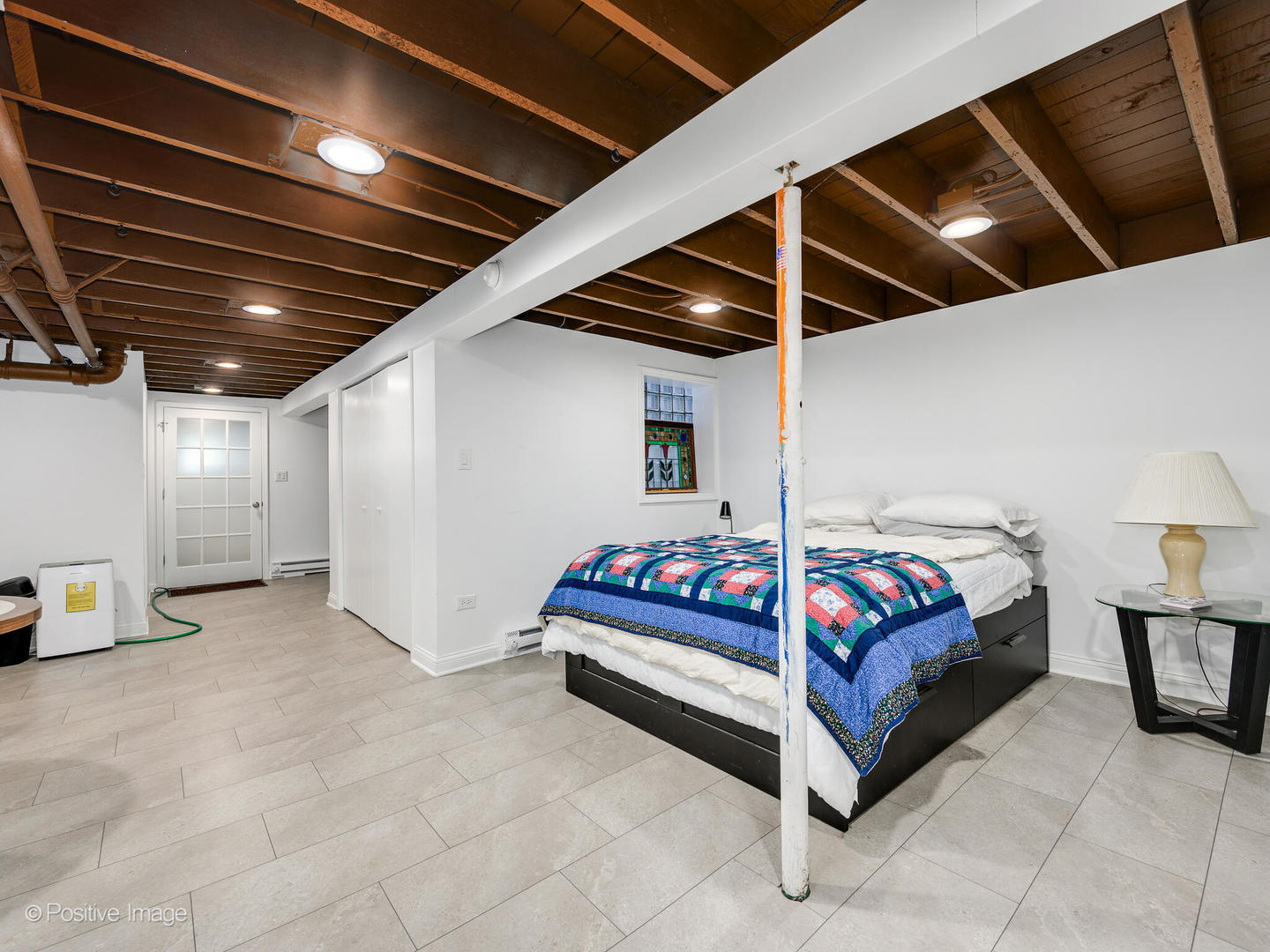 3016 South Throop Street Chicago, IL 60608 - Photo 24 of 32 a spacious bedroom with a bed and a chandelier