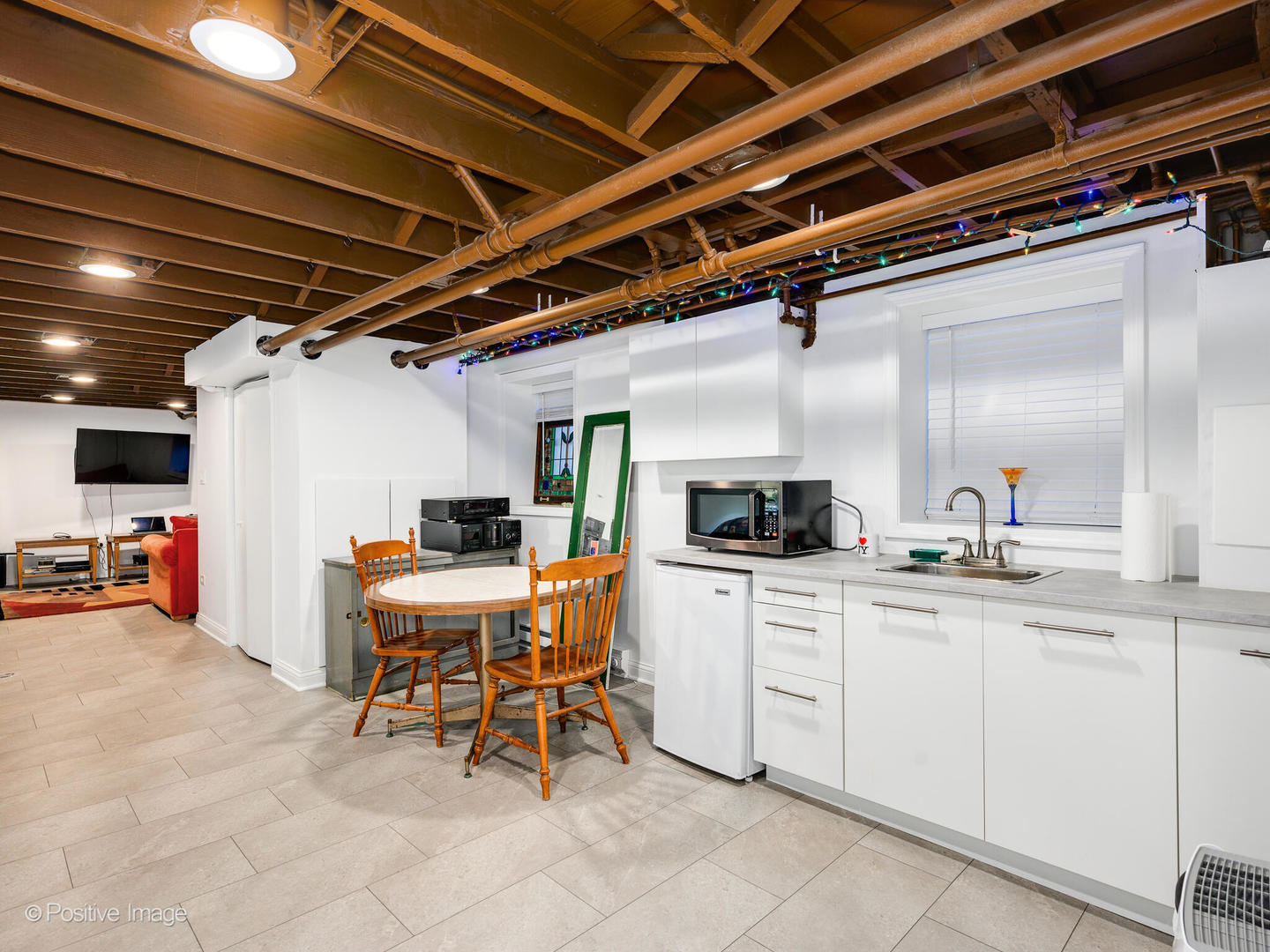 3016 South Throop Street Chicago, IL 60608 - Photo 25 of 32 a kitchen with a sink a table and chairs