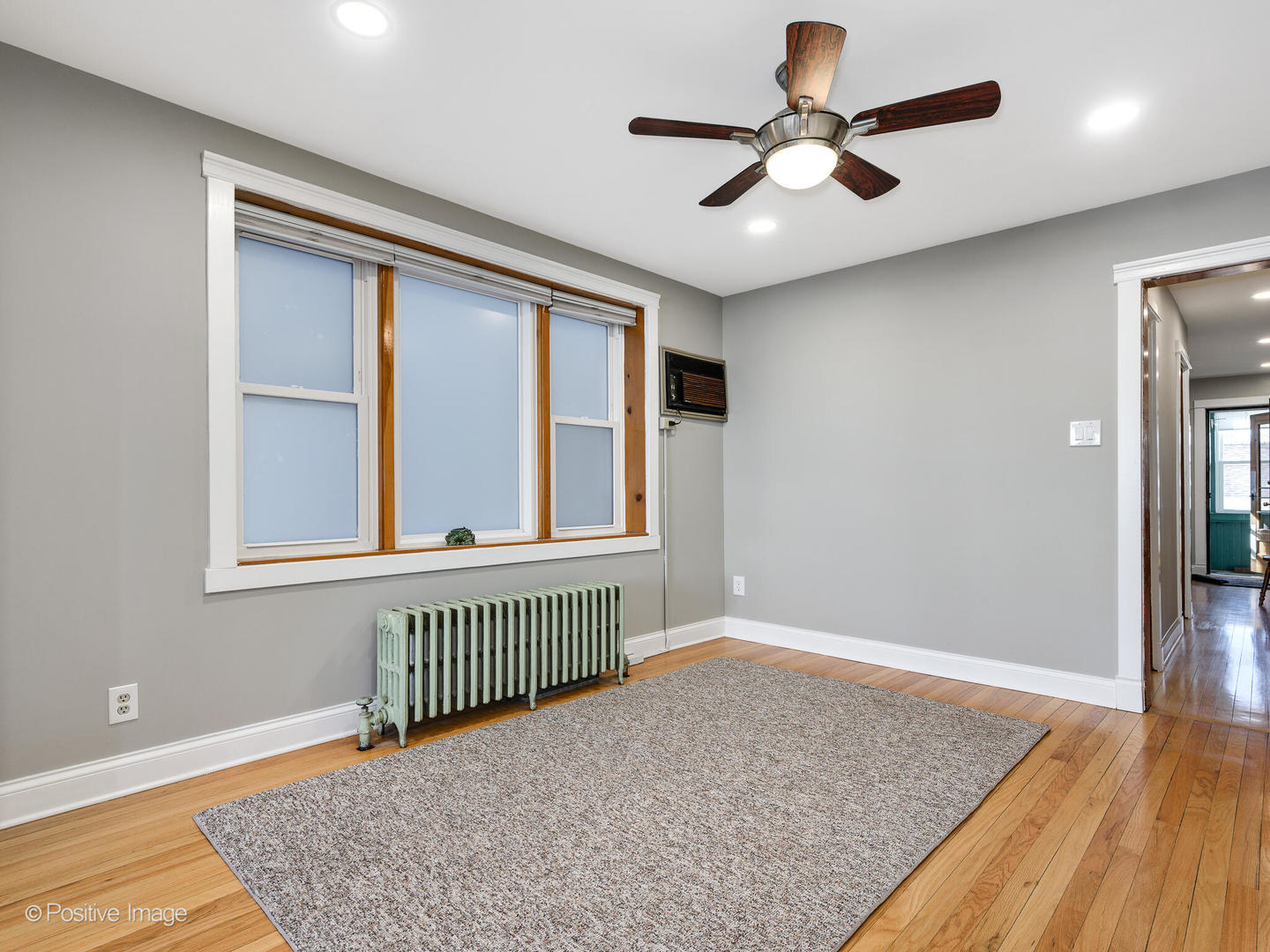 3016 South Throop Street Chicago, IL 60608 - Photo 5 of 32 a view of an empty room with window and wooden floor