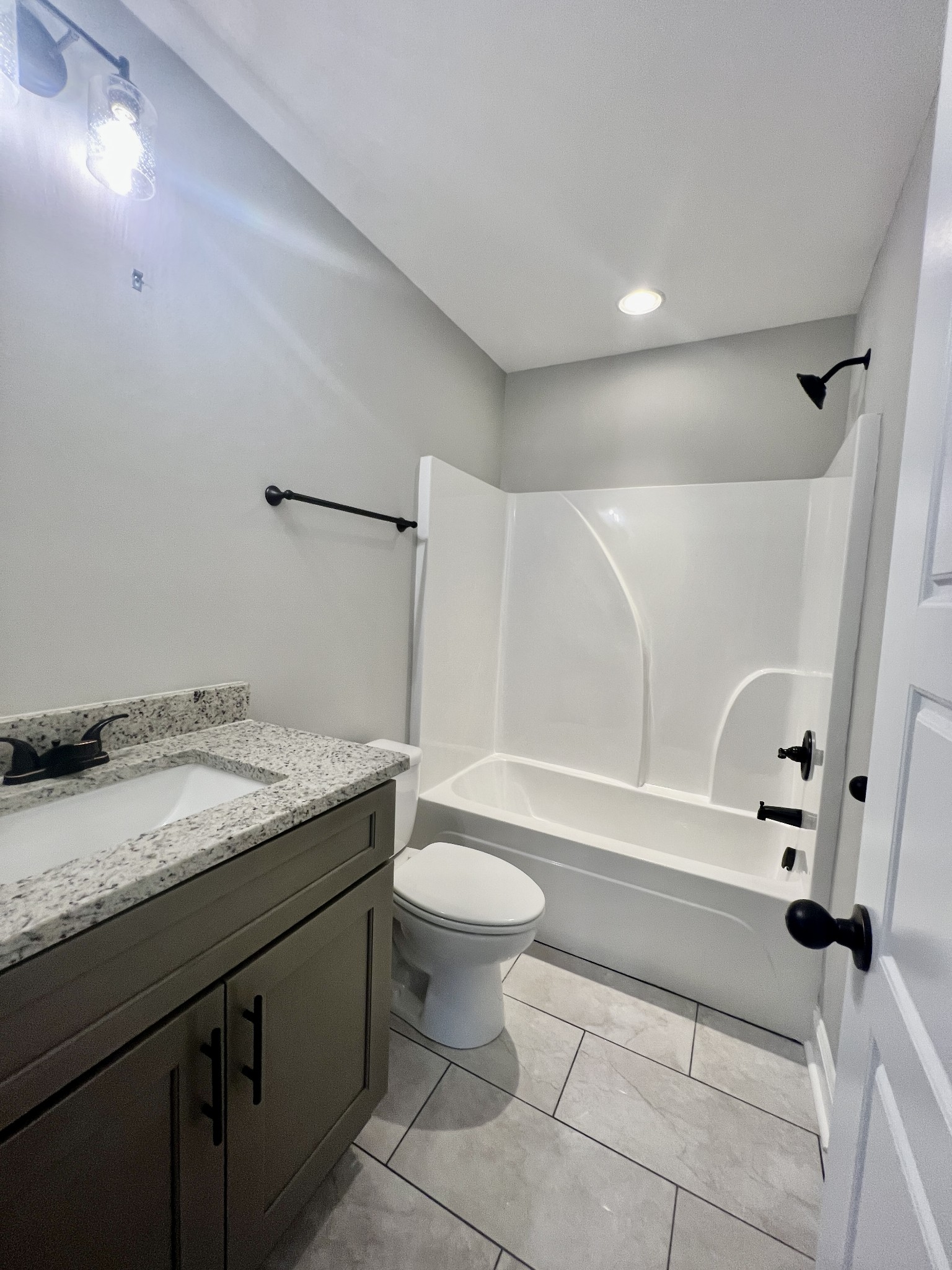 557 Hiwassee Road Lebanon, TN 37087 - Photo 20 of 27 a bathroom with a granite countertop sink toilet and shower