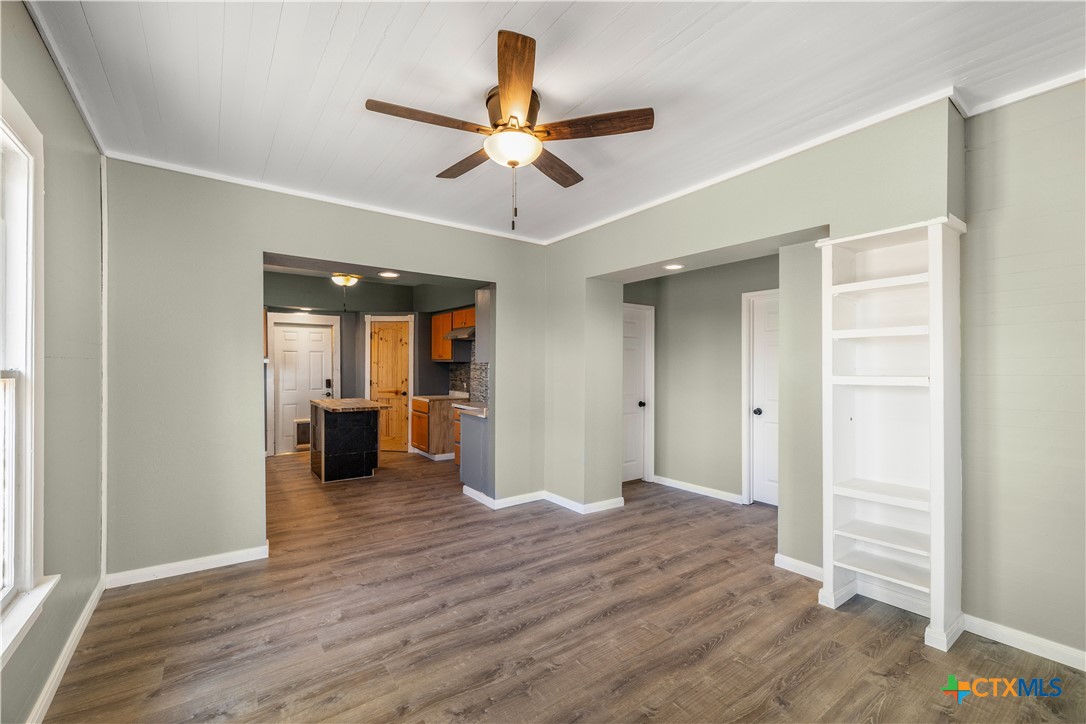 2205 Meyersville Road Meyersville, TX 77974 - Photo 12 of 22 a view of empty room with wooden floor and ceiling fan