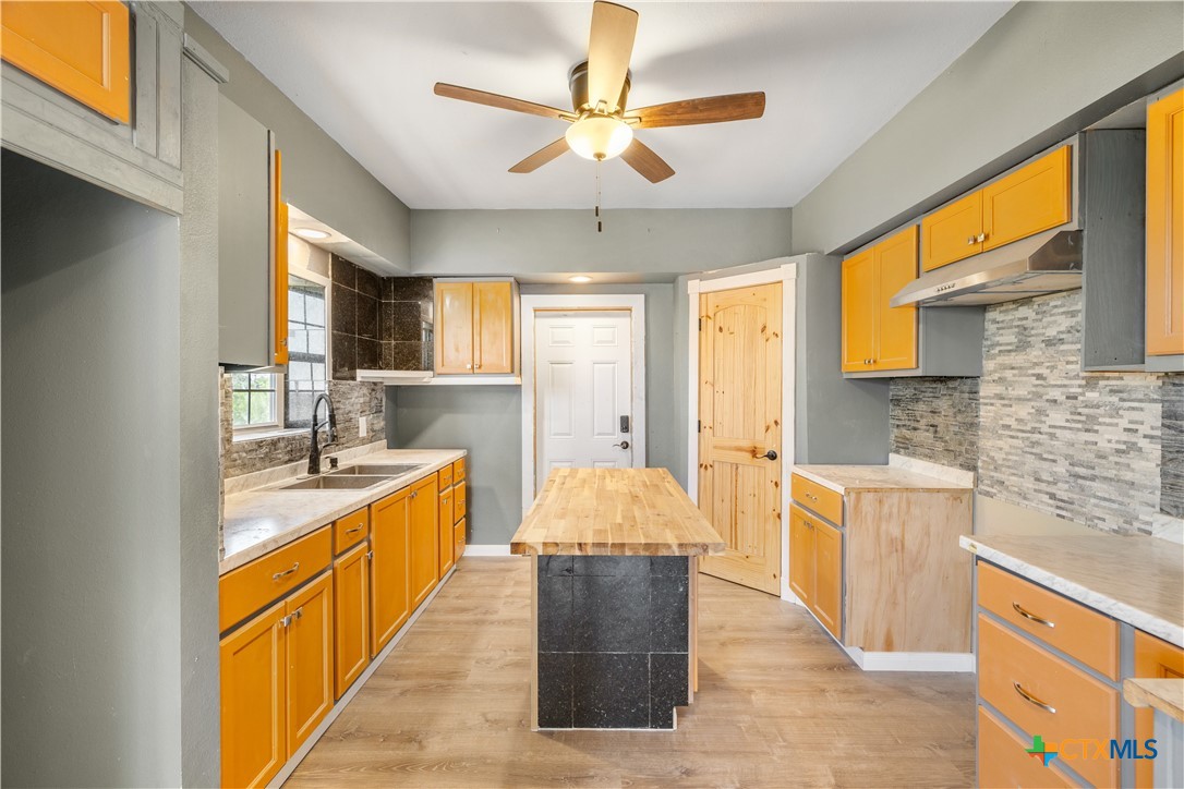 2205 Meyersville Road Meyersville, TX 77974 - Photo 13 of 22 a kitchen with stainless steel appliances granite countertop a sink stove and refrigerator