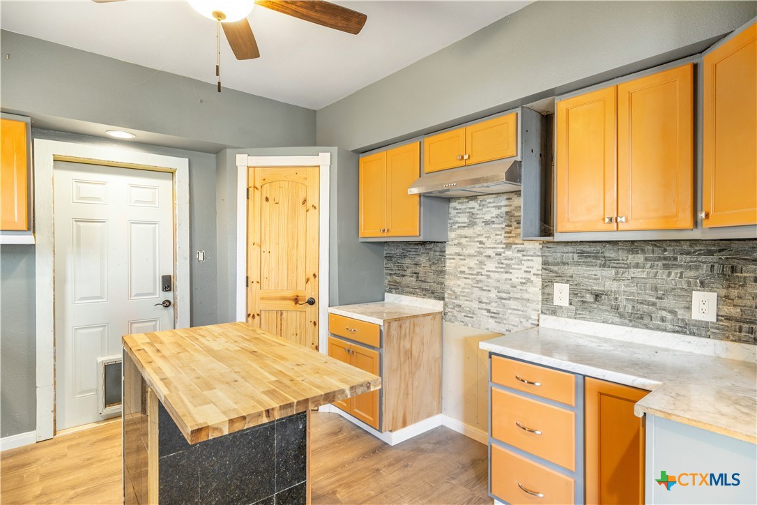 2205 Meyersville Road Meyersville, TX 77974 - Photo 15 of 22 a kitchen with a stove a sink cabinetry and a large window