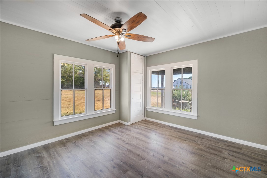 2205 Meyersville Road Meyersville, TX 77974 - Photo 16 of 22 a view of an empty room with a window and wooden floor