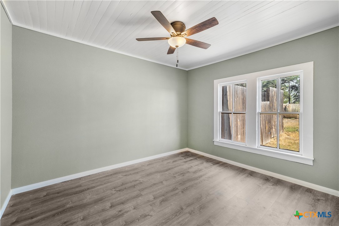 2205 Meyersville Road Meyersville, TX 77974 - Photo 20 of 22 an empty room with wooden floor and windows