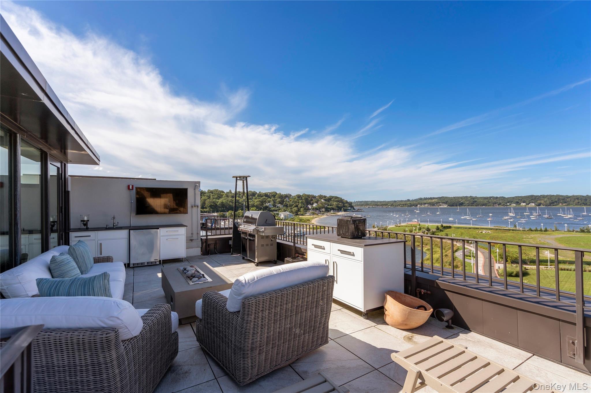100 Garvies Point Road, Unit 1309 Glen Cove, NY 11542 - Photo 21 of 36 View of rooftop terrace with an outdoor kitchen and a water view