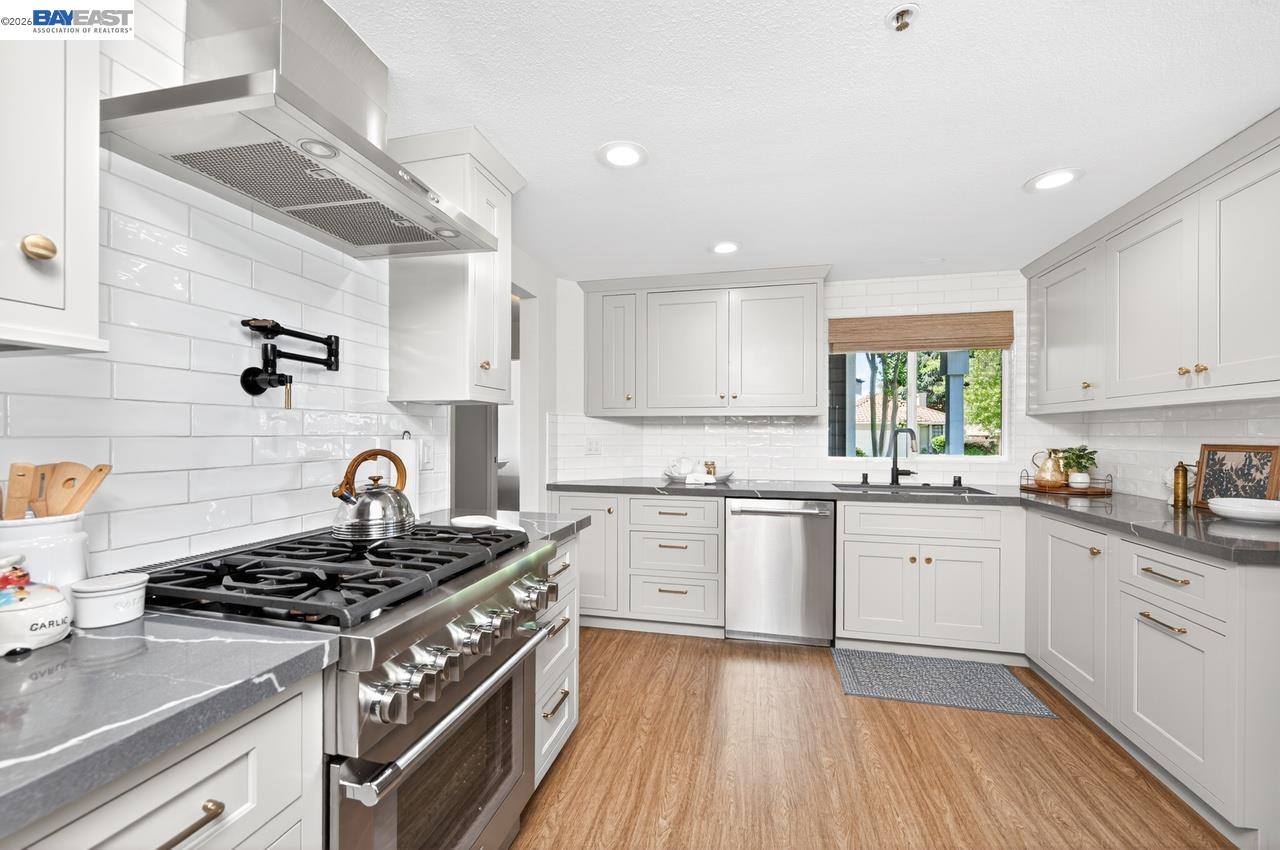 308 Mulqueeney Street Livermore, CA 94550 - Photo 11 of 51 a kitchen with a stove top oven sink and cabinets