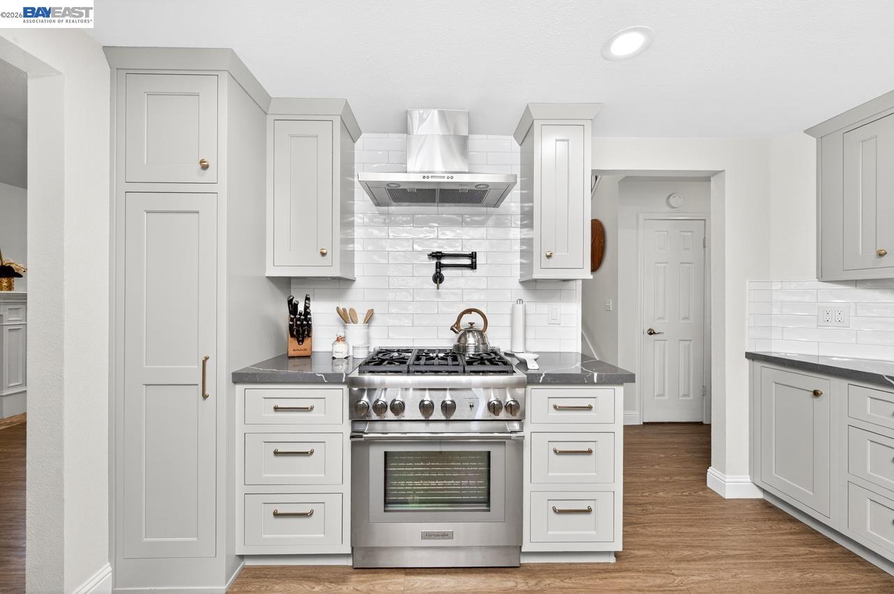 308 Mulqueeney Street Livermore, CA 94550 - Photo 12 of 51 a kitchen with stainless steel appliances a stove and cabinets