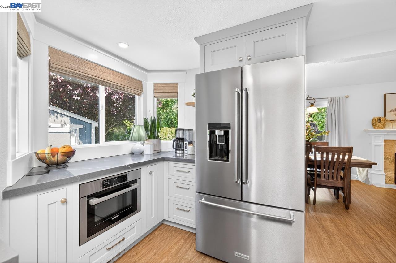 308 Mulqueeney Street Livermore, CA 94550 - Photo 15 of 51 a kitchen with stainless steel appliances a refrigerator a stove a microwave and dining table