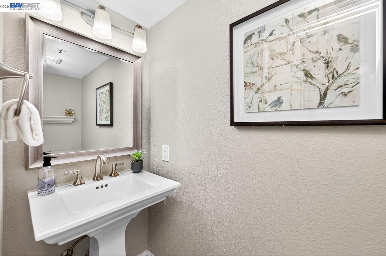 308 Mulqueeney Street Livermore, CA 94550 - Photo 16 of 51 a bathroom with a sink and a mirror