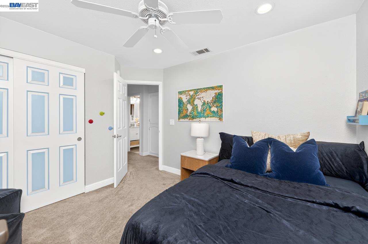 308 Mulqueeney Street Livermore, CA 94550 - Photo 18 of 51 a bedroom with a bed and a chandelier