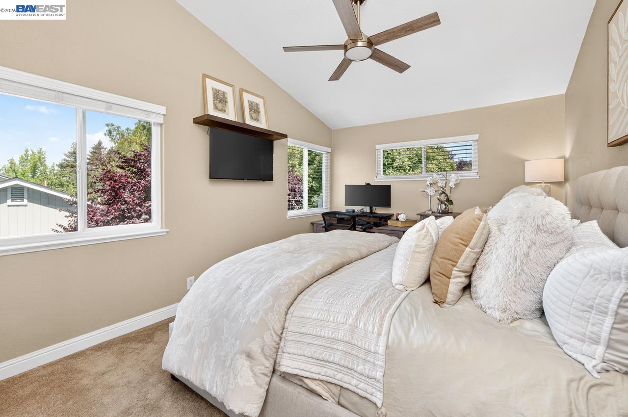 308 Mulqueeney Street Livermore, CA 94550 - Photo 22 of 51 a bedroom with a large bed a flat tv screen and a window