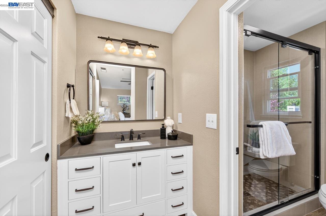 308 Mulqueeney Street Livermore, CA 94550 - Photo 25 of 51 a bathroom with a granite countertop sink and a mirror