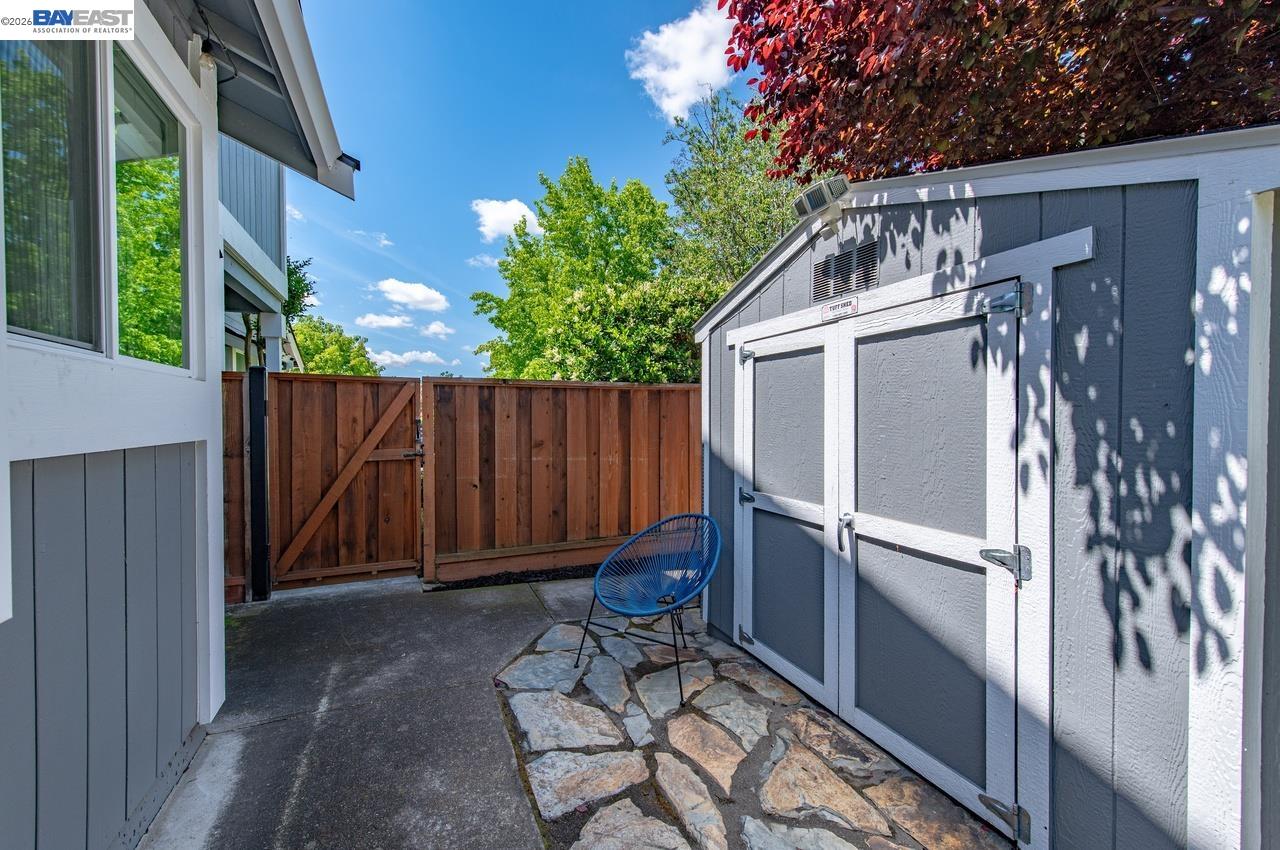 308 Mulqueeney Street Livermore, CA 94550 - Photo 34 of 51 a view of a backyard with a large tree and wooden fence