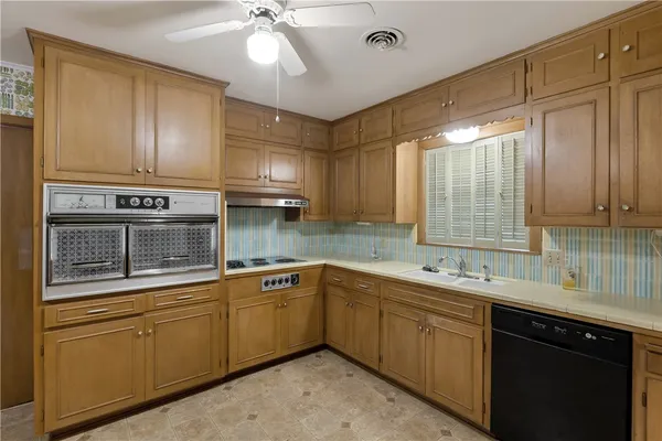 a kitchen with stainless steel appliances granite countertop a refrigerator and a stove