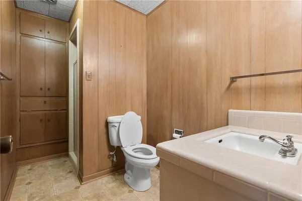 a view of a hallway with wooden floor and a door