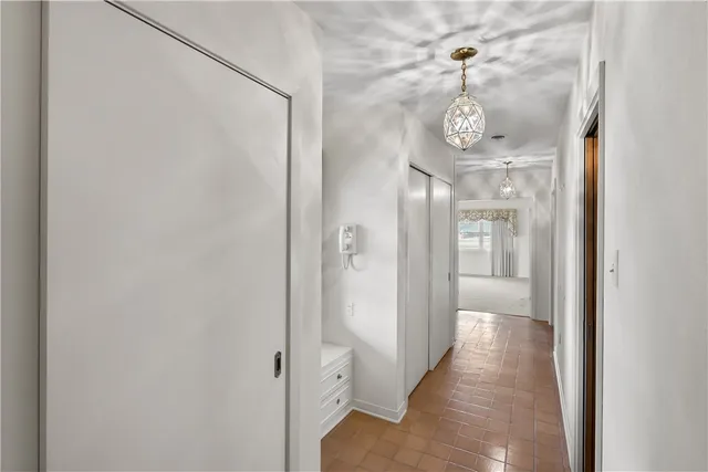 an empty room with windows and cabinet