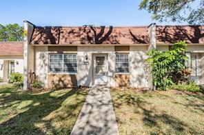 11511 113th Street, Unit 22E Largo, FL 33778 - Photo 1 of 1 front view of a house with a yard
