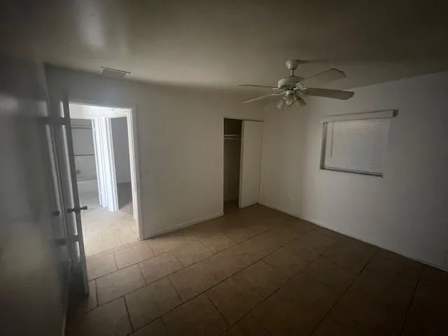 an empty room with a empty space and a ceiling fan