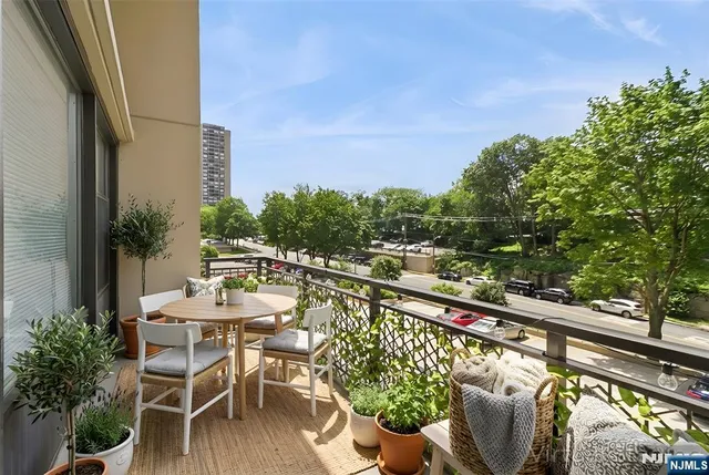 a view of swimming pool with outdoor seating and plants
