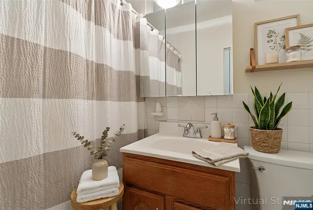 a bathroom with a sink a toilet and a mirror