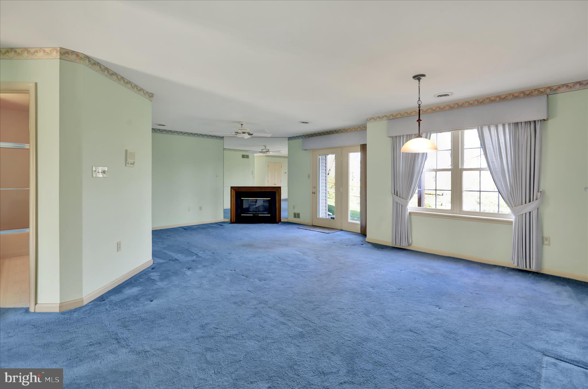 146 Heather Lane Reading, PA 19610 - Photo 3 of 25 an empty room with fireplace and windows