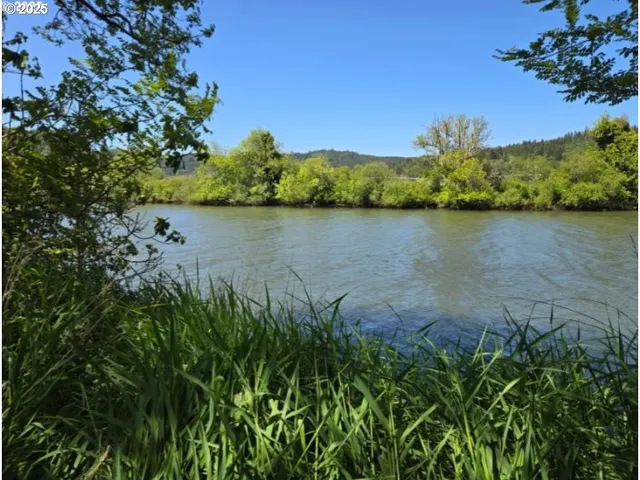 a view of a lake with a house in the background