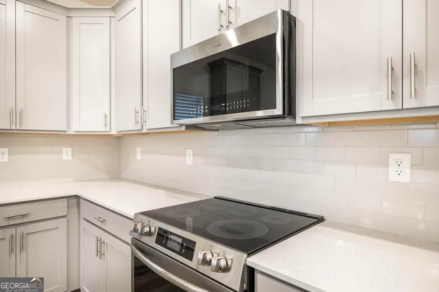 a kitchen with a stove and a microwave