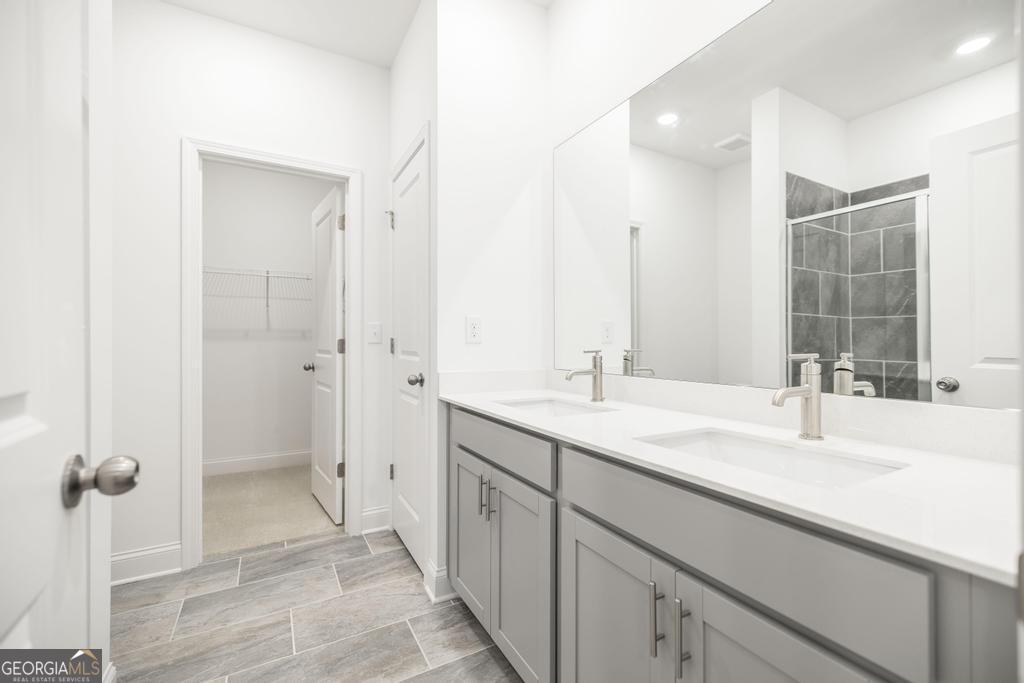 108 Palmetto Avenue Perry, GA 31069 - Photo 18 of 30 a bathroom with a double vanity sink mirror and shower