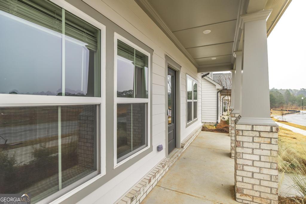 108 Palmetto Avenue Perry, GA 31069 - Photo 4 of 30 a view of a balcony with a floor to ceiling window and wooden floor