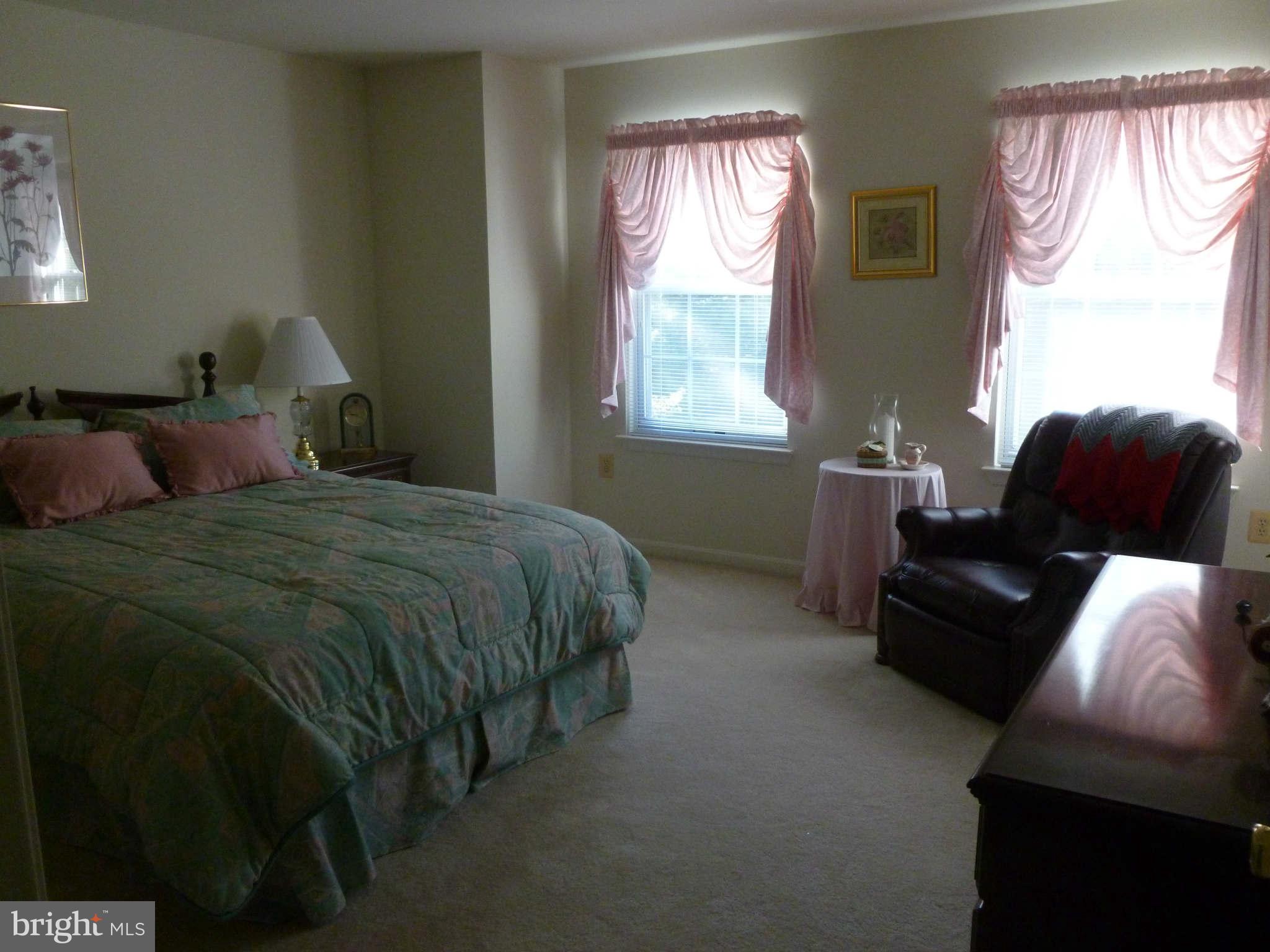670 Small Reward Road Huntingtown, MD 20639 - Photo 16 of 26 a bedroom with a bed and a couch