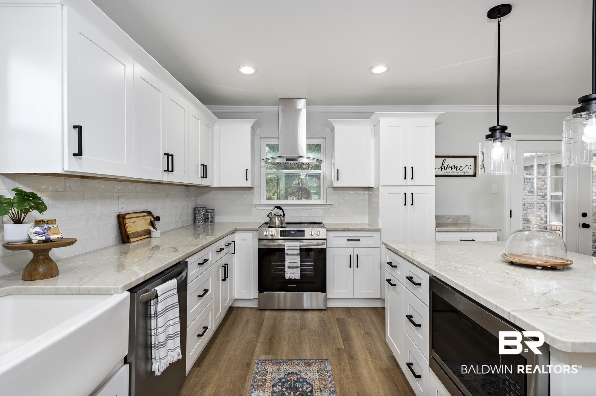 6001 Camp Halls Mill Road Mobile, AL 36619 - Photo 12 of 52 Kitchen with appliances with stainless steel finishes, crown molding, light stone countertops, dark wood finished floors, and island exhaust hood