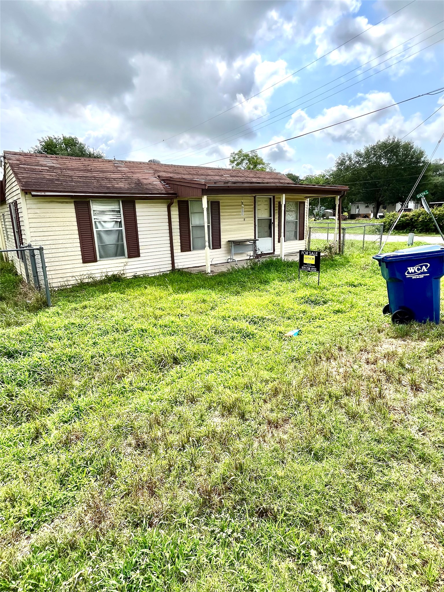 910 East E Street Eagle Lake, TX 77434 - Photo 6 of 12 a view of a house with a backyard