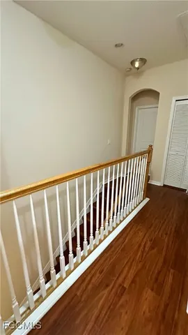 a view of empty room with wooden floor and cabinet
