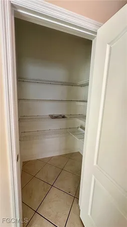 a kitchen with granite countertop white cabinets sink and window
