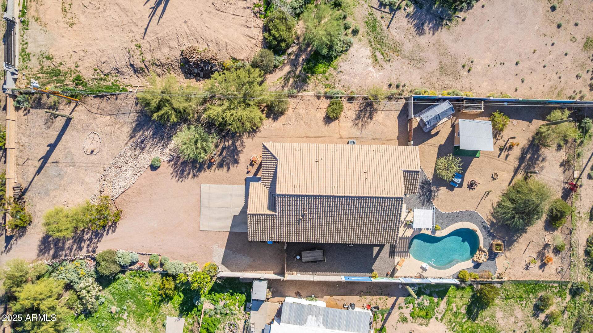 614 North Tomahawk Road Apache Junction, AZ 85119 - Photo 1 of 48 an aerial view of a house with a yard and large trees