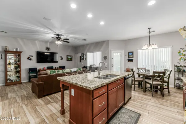 a large kitchen with kitchen island a sink table and chairs