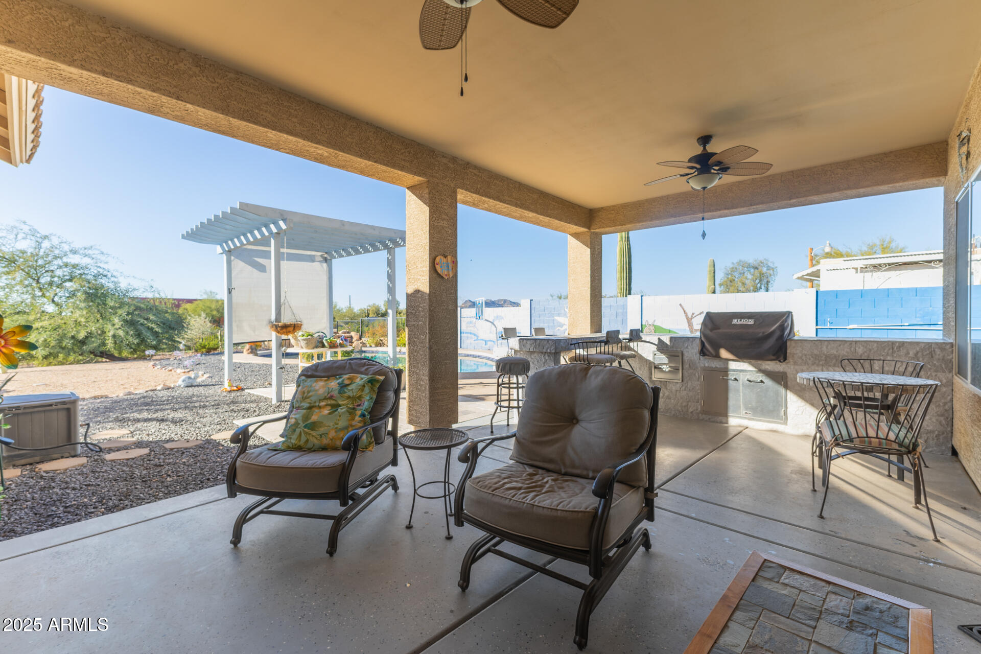 614 North Tomahawk Road Apache Junction, AZ 85119 - Photo 26 of 48 a living room with furniture and a floor to ceiling window