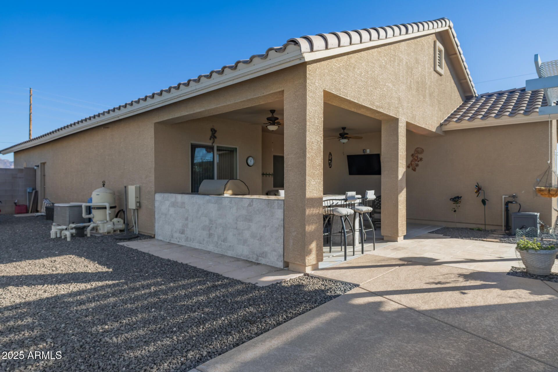 614 North Tomahawk Road Apache Junction, AZ 85119 - Photo 30 of 48 a view of a patio with a table and chairs and potted plants