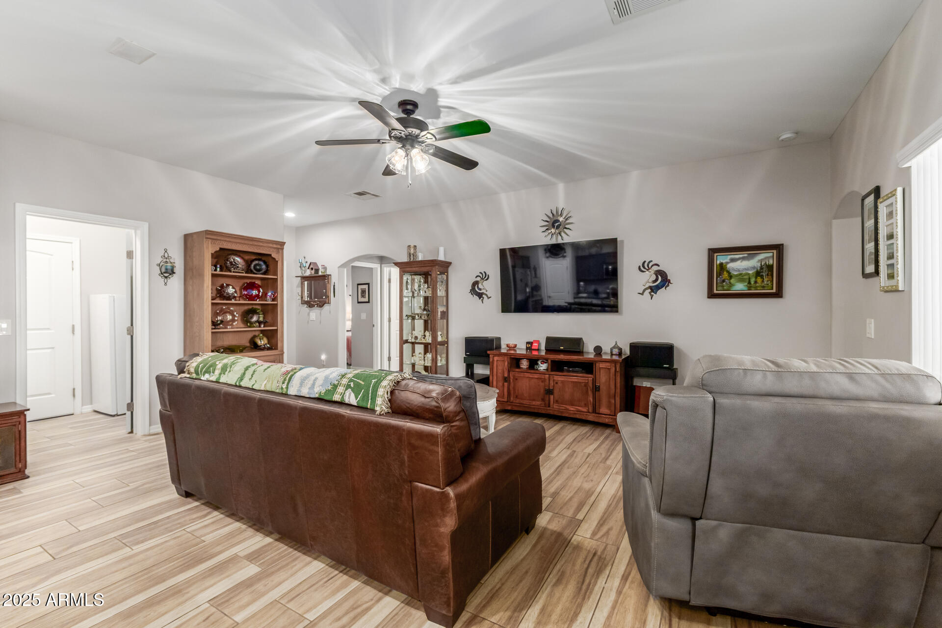 614 North Tomahawk Road Apache Junction, AZ 85119 - Photo 6 of 48 a living room with furniture and a flat screen tv
