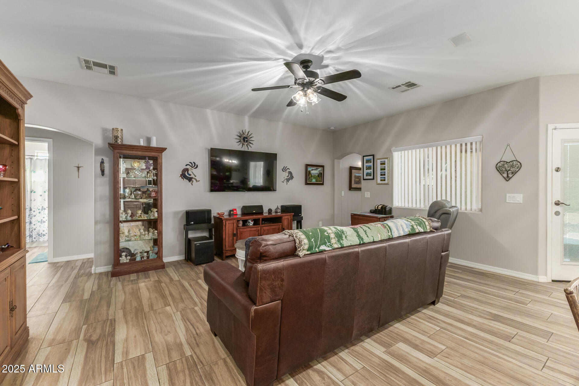 614 North Tomahawk Road Apache Junction, AZ 85119 - Photo 7 of 48 a living room with furniture and a flat screen tv