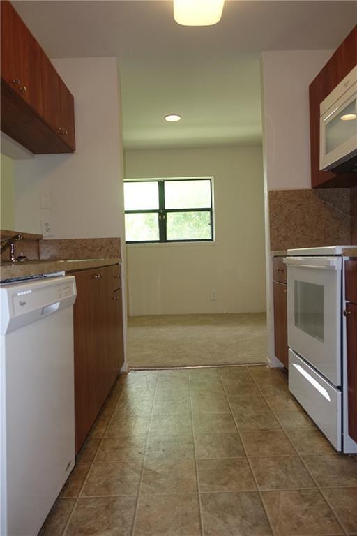 4088 North Pine Island Road, Unit 409 Sunrise, FL 33351 - Photo 5 of 18 a room with a stove top oven and cabinets