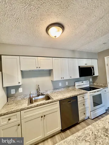 a kitchen with a sink and a stove