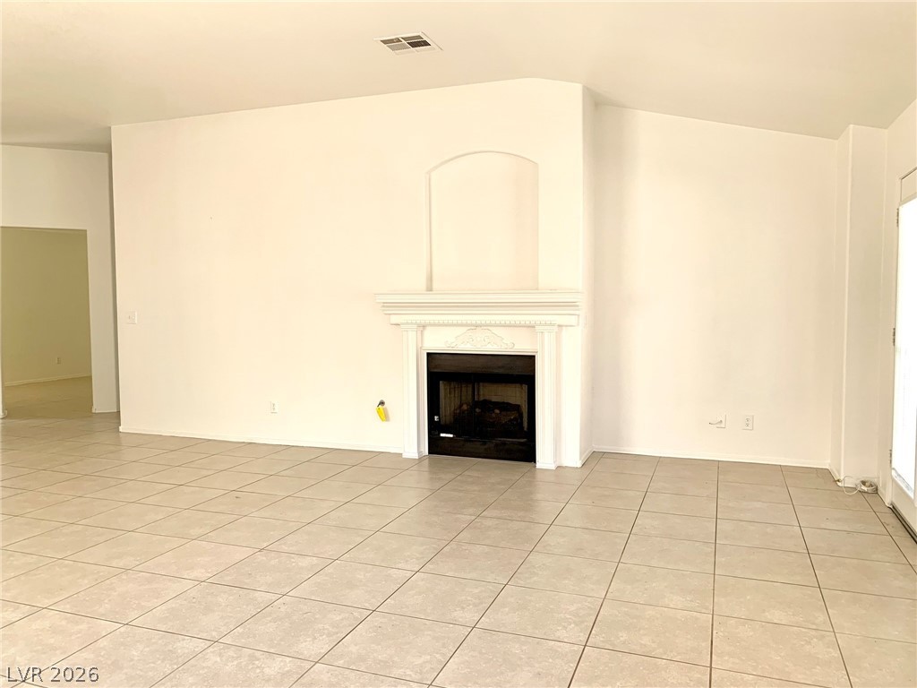 3821 Bombastic Court Las Vegas, NV 89147 - Photo 6 of 36 This expansive living area features a charming fireplace, perfect for gatherings and relaxation.