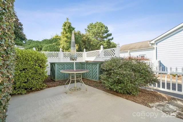 a view of a house with a yard patio and furniture